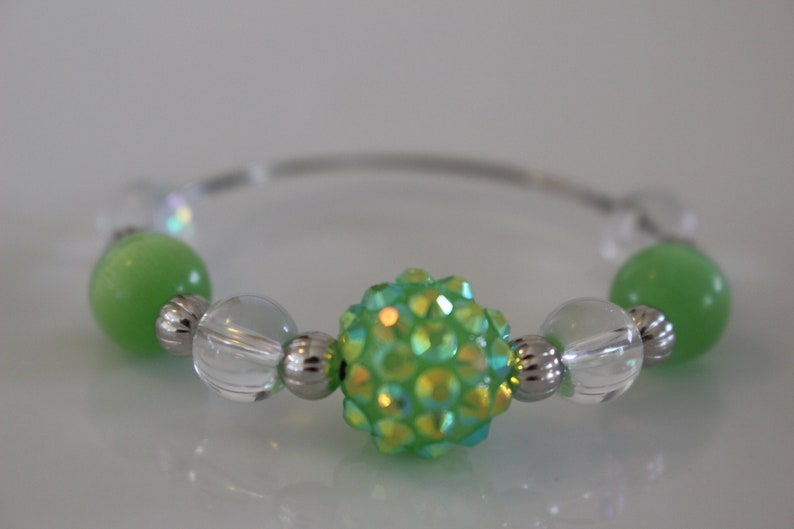 Clear and silver beads add to the look of these fun napkin rings Set of 4. Fun green glass bead napkin rings