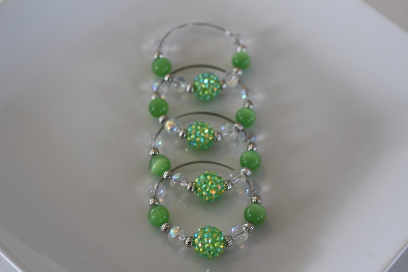 Clear and silver beads add to the look of these fun napkin rings Set of 4. Fun green glass bead napkin rings