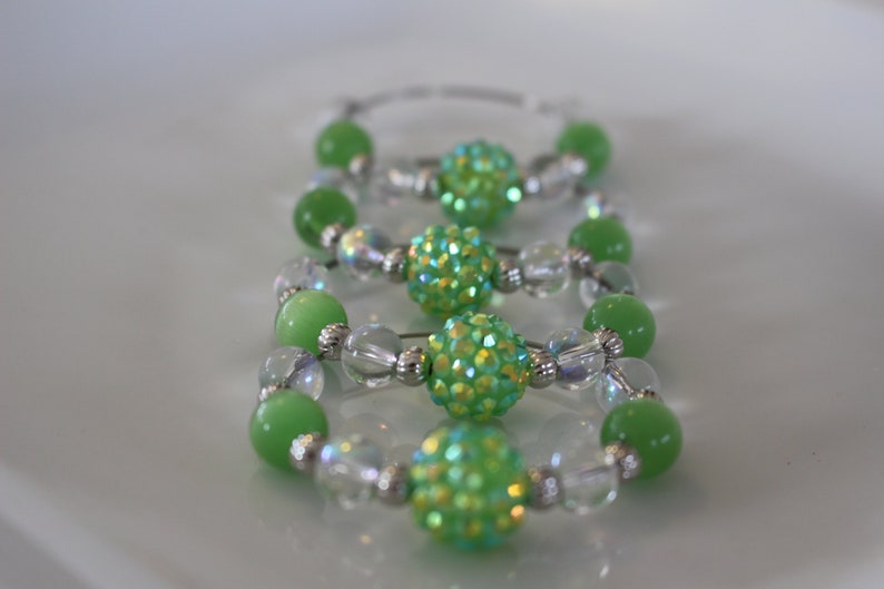Clear and silver beads add to the look of these fun napkin rings Set of 4. Fun green glass bead napkin rings