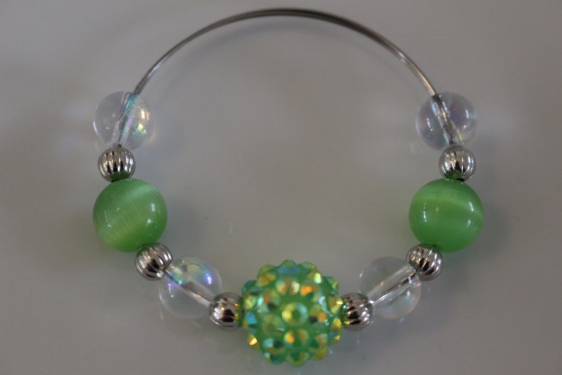 Clear and silver beads add to the look of these fun napkin rings Set of 4. Fun green glass bead napkin rings