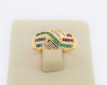 May include: A gold ring with a twisted band set with emerald, sapphire, ruby, and diamond stones.