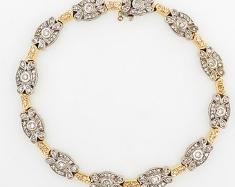 May include: A delicate diamond bracelet with a two-tone design. The bracelet features alternating gold and silver links, each adorned with a small round diamond.