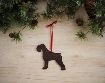 May include: A wooden Christmas ornament shaped like a black dog with a red ribbon attached.