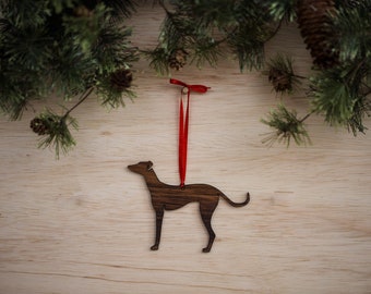 May include: Wooden Christmas ornament shaped like a greyhound dog with a red ribbon attached.