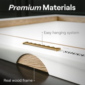 May include: Close-up of a canvas print with a real wood frame and an easy hanging system. The frame is made of natural wood with a visible grain pattern. The hanging system is a gold-colored metal hook.