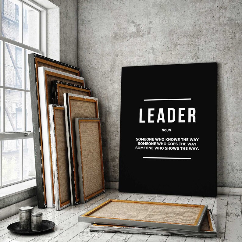 May include: Black and white canvas print with the word "LEADER" in large white letters. The definition of the word is below in smaller white letters: "Someone who knows the way. Someone who goes the way. Someone who shows the way."