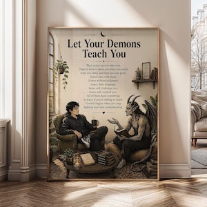 May include: A rectangular wall art print titled Let Your Demons Teach You, featuring a person in a hoodie sitting in an armchair across from a horned, winged demon. Both figures are in a room with a coffee table, books, and plants.