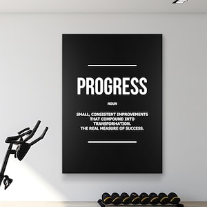 May include: A black poster with the word "PROGRESS" in white, along with its definition. The image includes exercise equipment in the foreground. The poster is mounted on a white wall.