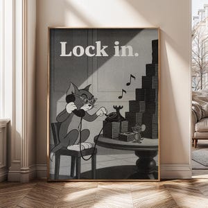May include: Black and white cartoon print featuring Tom the cat wearing glasses and a headset, dialing a rotary phone. The text "Lock in." is at the top. A stack of blocks and Jerry the mouse are also in the image.
