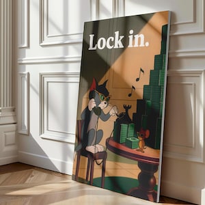 May include: A framed canvas print featuring Tom and Jerry cartoon characters. Tom, wearing sunglasses and headphones, is on the phone. Jerry is standing on a table with stacks of money. The text "Lock in" is at the top.