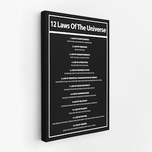 May include: Black framed canvas print featuring the text "12 Laws Of The Universe" in white. The print lists twelve laws with brief descriptions, including the Law of Attraction and the Law of Vibration. The background is black.
