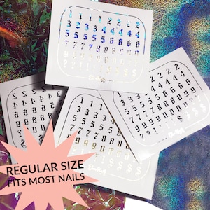 May include: Four sheets of white paper with black numbers printed on them. The numbers are arranged in a grid pattern. The sheets are labeled "Regular Size Fits Most Nails".