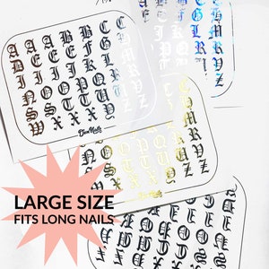 May include: Four sheets of nail art stickers with a gothic alphabet in black, gold, and silver. The stickers are labeled "Large Size Fits Long Nails".