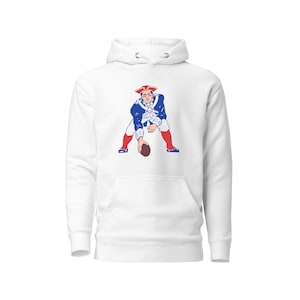 May include: White hooded sweatshirt with a blue and red graphic of a football player in a vintage style.