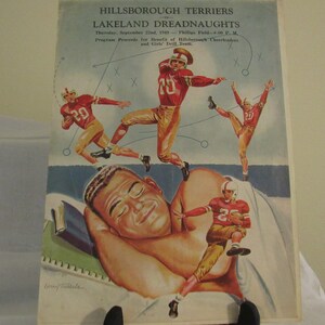 May include: A vintage program for a football game between the Hillsborough Terriers and the Lakeland Dreadnaughts. The program features a cartoon illustration of a sleeping man with football players in the background. The game was played on Thursday, September 22nd, 1943 at Philips Field.