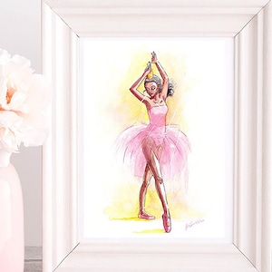 May include: Watercolor painting of a ballerina in a pink tutu and pointe shoes, framed in a white wooden frame. The artwork features a yellow and white background. A pink vase with a white flower is in the foreground.