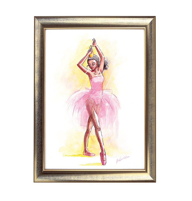 May include: Watercolor painting of a ballerina in a pink tutu and pointe shoes, framed in a gold-toned frame. The ballerina is wearing a crown and is posed with arms raised. The background is a soft yellow and white.