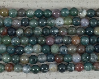 May include: A strand of green, brown, and gray agate beads. The beads are round and have a smooth, polished finish.