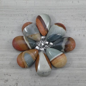 May include: Eight teardrop-shaped pendants made of colourful, banded agate with silver bail loops. The stones are a mix of brown, grey, and white.