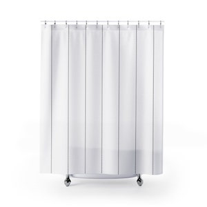 May include: White shower curtain with black dotted lines. The curtain is hanging from a chrome shower rod.