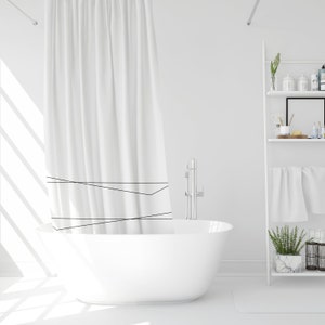May include: A white bathtub with a white shower curtain with black lines. The bathtub is in a white bathroom with a white shelf unit with towels and plants.