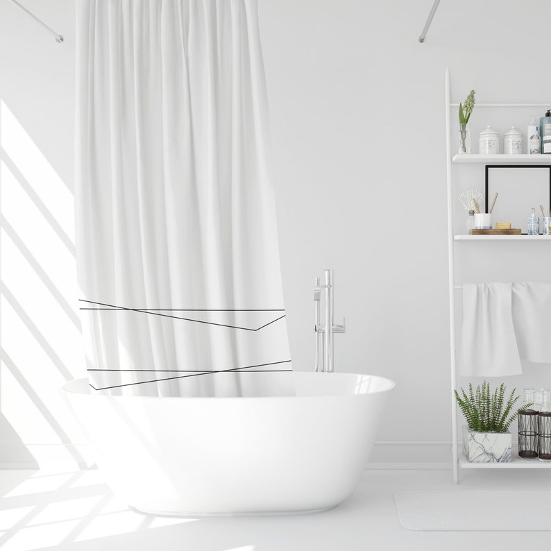 May include: A white bathtub with a white shower curtain with black lines. The bathtub is in a white bathroom with a white shelf unit with towels and plants.