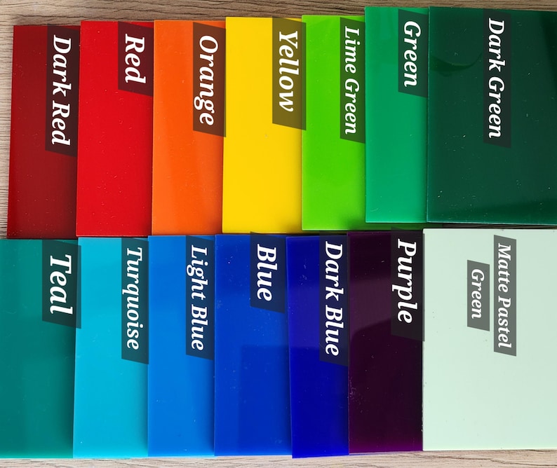 May include: A collection of rectangular acrylic swatches in various colors, each labeled with its corresponding name: Dark Red, Red, Orange, Yellow, Lime Green, Green, Dark Green, Teal, Turquoise, Light Blue, Blue, Dark Blue, Purple, and Matte Pastel Green.
