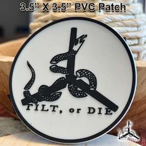May include: A 3.5-inch by 3.5-inch PVC patch with a white background and a black design. The design features a snake wrapped around a pole, with the words "TILT, or DIE" below. The patch has a black border.