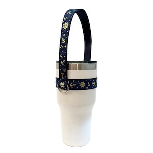 Navy blue tumbler handle with gold metallic anchors and ships wheel print.