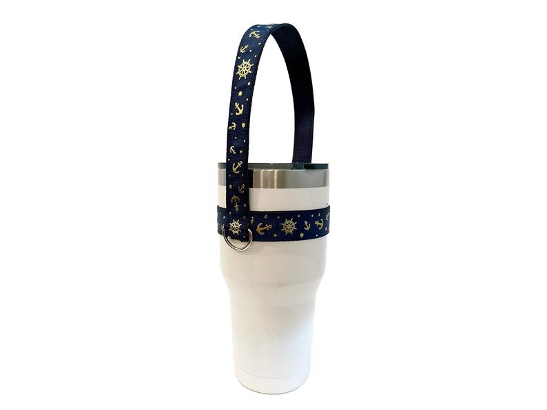 Navy blue tumbler handle with gold metallic anchors and ships wheel print.