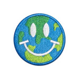 May include: A blue and green embroidered patch of the Earth with a white smiley face.