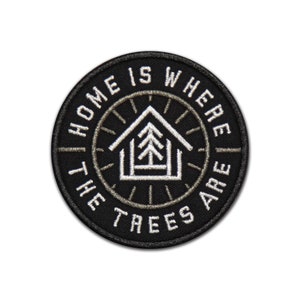 May include: Black and white embroidered patch with the text "Home is where the trees are" in a circle around a stylized house with a tree inside.