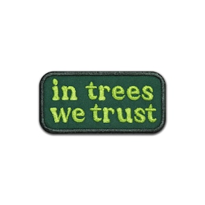 May include: Green embroidered patch with the text "in trees we trust" in a light green color.