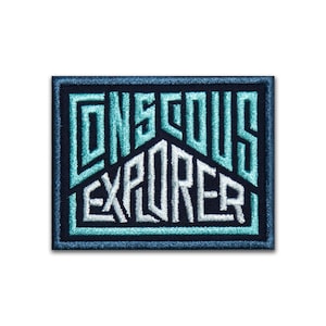 May include: A blue and white embroidered patch with the text "Conscious Explorer" on a black background.