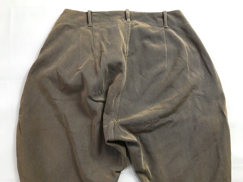 May include: A pair of brown corduroy pants with a center seam down the back.