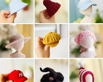 May include: A collection of handmade crochet hats in various styles and colors. Includes a light blue visor, a burgundy beanie, a beige sun hat, a yellow beret, a pink cloche, a red baseball cap with a white logo, a black witch hat, and a red and white striped winter hat.