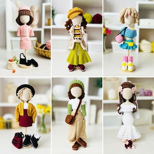 Könnte beinhalten: Eine Sammlung von sechs handgefertigten Häkelpuppen, jede mit einzigartigen Outfits und Accessoires. Die Puppen zeigen verschiedene Frisuren und Kleidungsstücke, darunter Kleider, Jacken und Hüte. Zu den Accessoires gehören Handtaschen, Schuhe und kleine Taschen. Die Puppen werden auf Holzständern präsentiert.