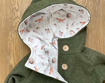 May include: A green hooded jacket with a white lining featuring a woodland animal print. The jacket has three brown buttons.