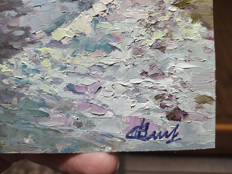 May include: A close-up of a textured, abstract painting in shades of gray, white, and purple. The painting is signed in the bottom right corner with the artist's name "Daryl".
