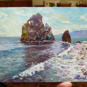 May include: A painting of two rocky cliffs rising from the ocean. The cliffs are brown and gray, and the water is a light blue with white waves. The sky is a light blue with white clouds.