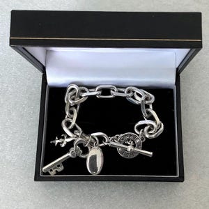 Vintage Monet Silvertone Bracelet With Three Dangling Charms