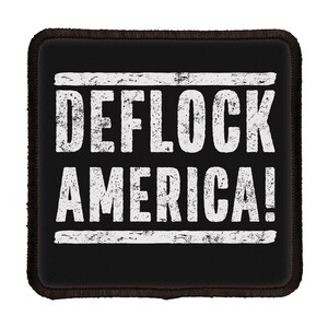 May include: A square black patch with rounded corners and a dark stitched border. The center features the white text DEFLOCK AMERICA! in a distressed, weathered font, positioned between two horizontal white lines with a matching worn texture.