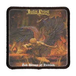 May include: A black and brown embroidered patch featuring the text "Judas Priest" and "Sad Wings of Destiny" in white. The patch depicts a painting of an angel with black wings in a fiery landscape.