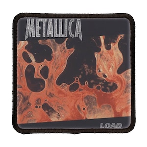 May include: A black and orange square patch with the band name "Metallica" in white text and the album title "Load" in white text at the bottom.