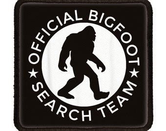 May include: Black and white patch with a white circle containing a silhouette of Bigfoot walking. The circle has the text "OFFICIAL BIGFOOT SEARCH TEAM" around it.