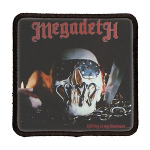 May include: A black and white patch with the band name "Megadeth" in red lettering. The patch features a skull with a metal eye patch and chains. The text "Killing is my business..." is at the bottom of the patch.