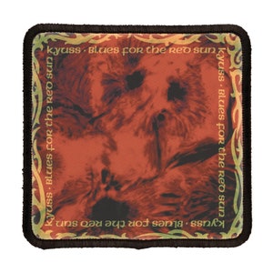 May include: A square patch with a black border and a red, orange, and yellow background. The text "kyuss Blues for the red sun" is repeated four times around the border in a gold font.