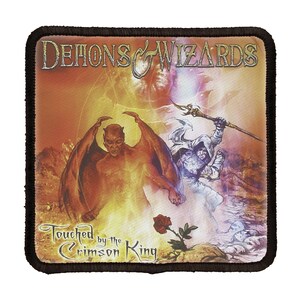 May include: A square patch with a black border featuring a fantasy illustration of a demon and a wizard. The text "Demons & Wizards" is at the top of the patch. The text "Touched by the Crimson King" is at the bottom of the patch.