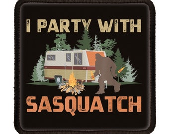 May include: A black and orange patch with the text "I Party With Sasquatch" in white. The patch features a cartoon image of a Bigfoot holding a beer bottle next to a camper van and a campfire.