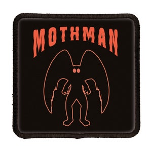 May include: Black patch with the text "MOTHMAN" in orange. A silhouette of a creature with large wings and glowing red eyes is below the text.